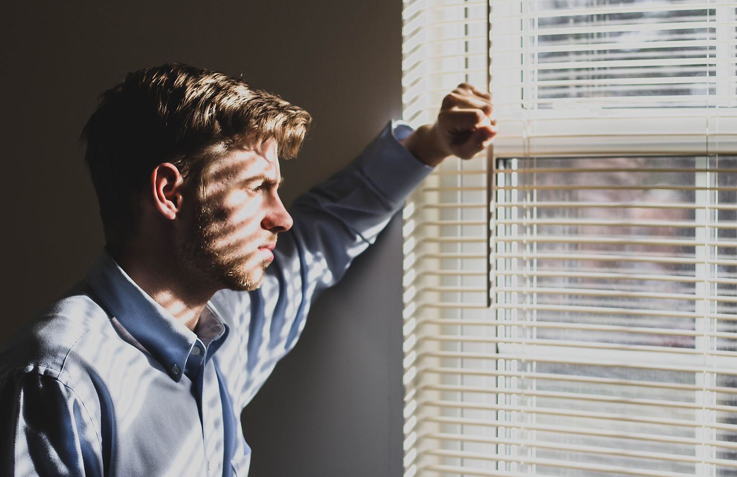 man looking out of window