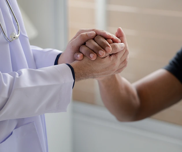Doctor holding patient’s hand