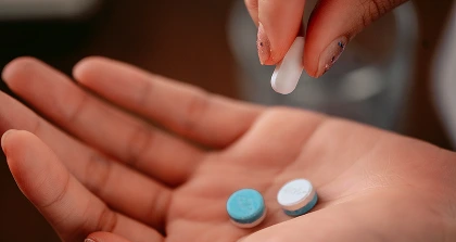 Hand holding multiple pills