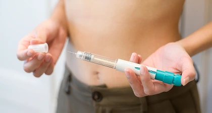 Person holding insulin pen