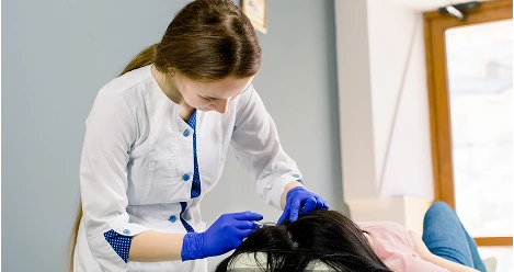 Clinician performing scalp treatment