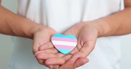 Hands holding transgender heart